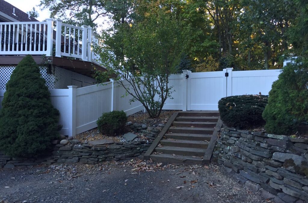 White PVC Fence Installed in Rock Wall